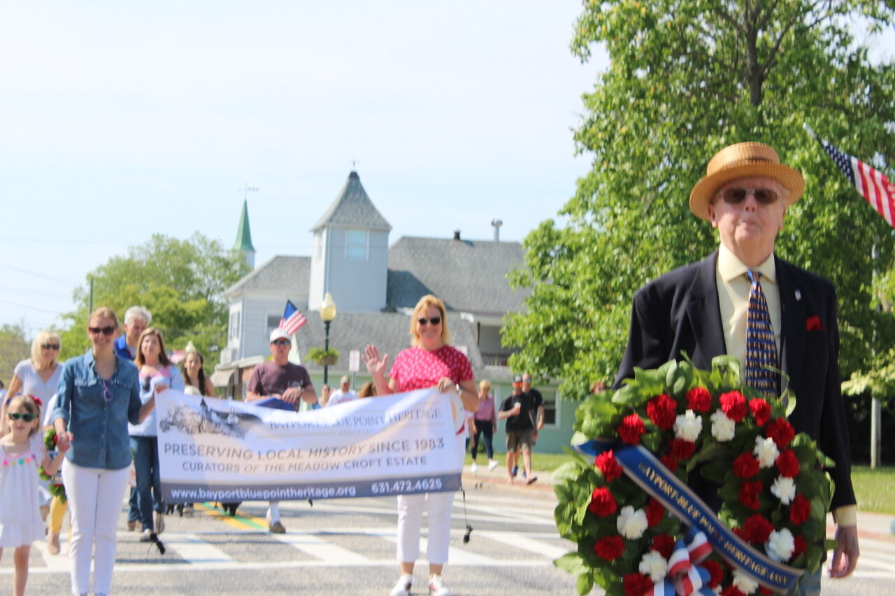 Docent Jerry McClusky leads the Bayport-Blue Point Heritage Association during the Blue Point Fire Department Memorial Day Parade.